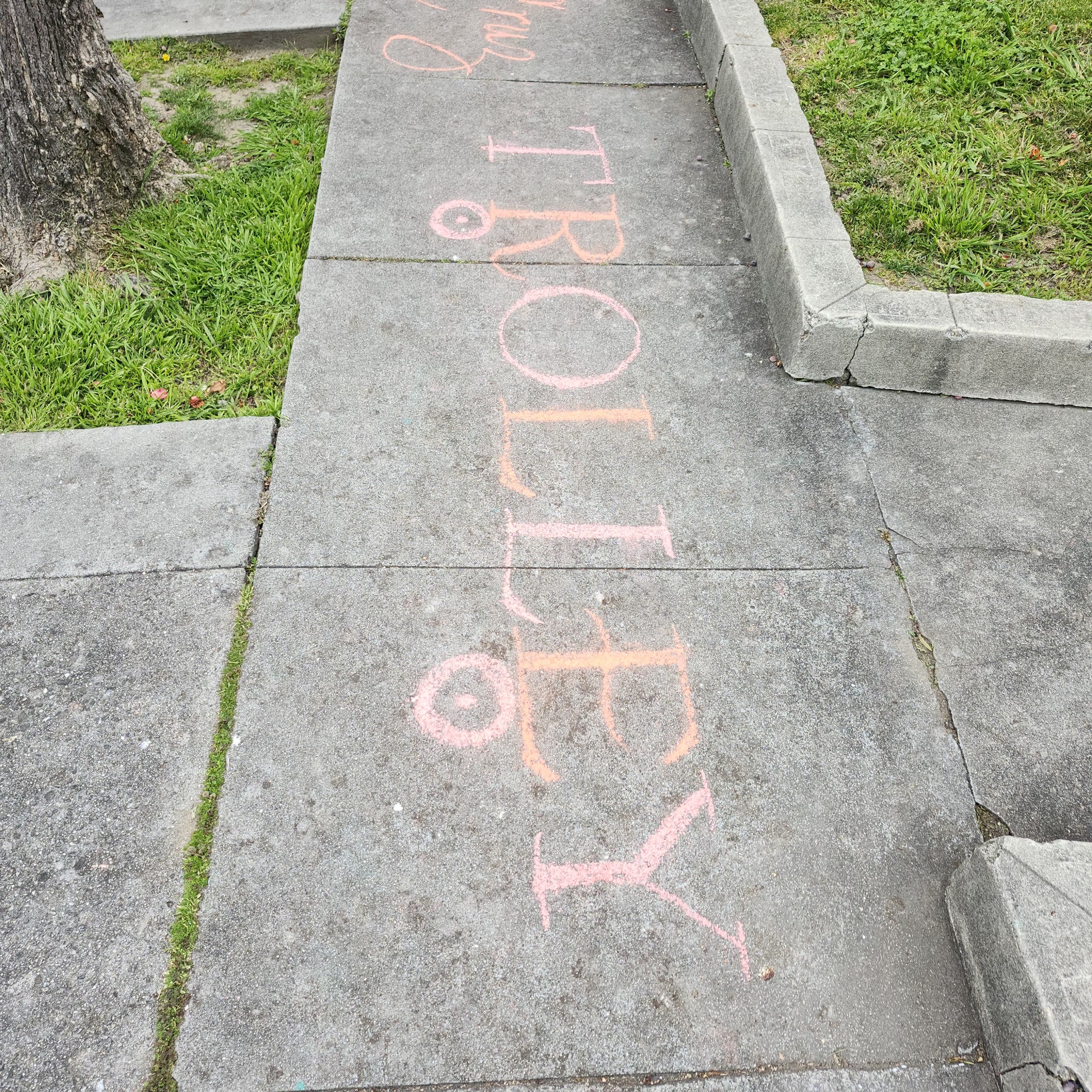 The word PROPERTY drawn in pink and orange chalk across the sidewalk game board
