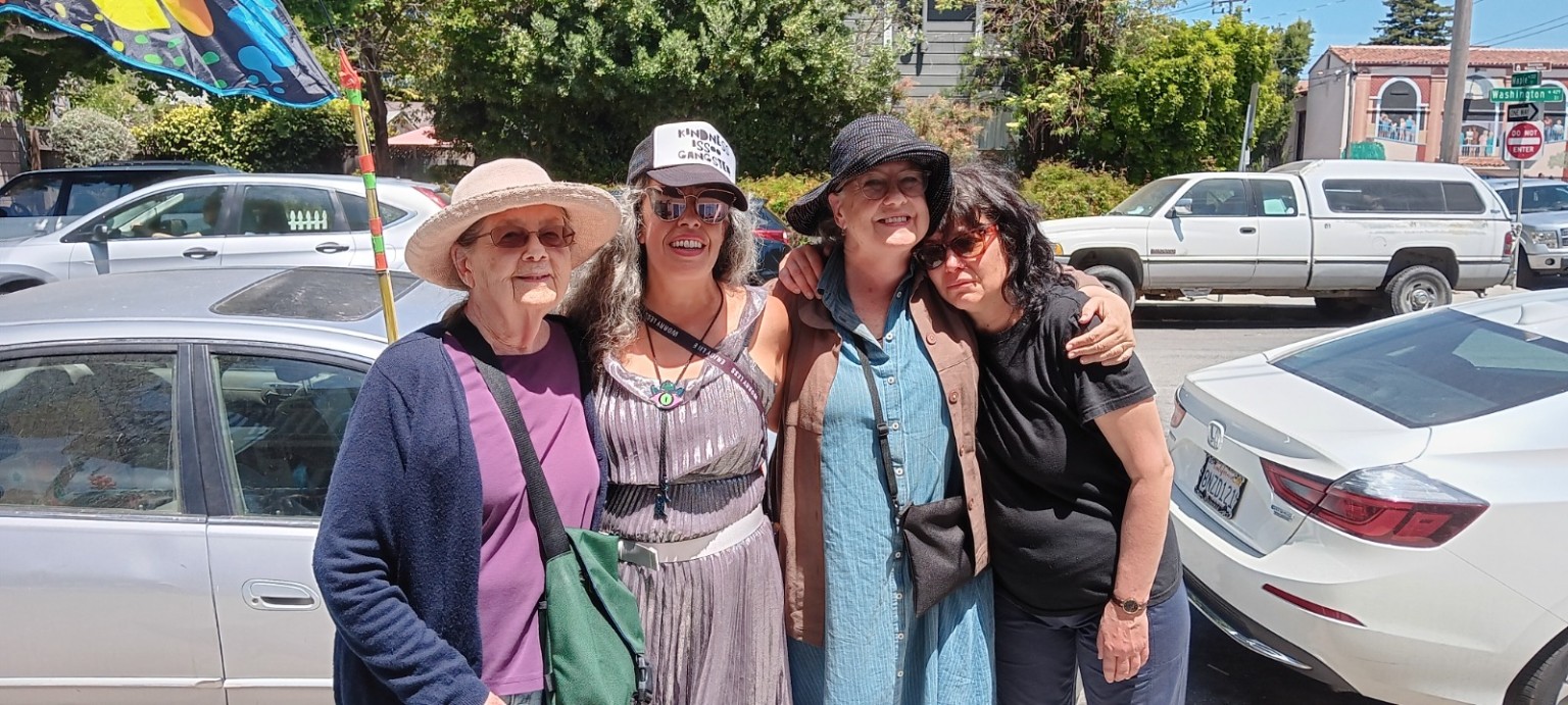 Four women standing together outside
